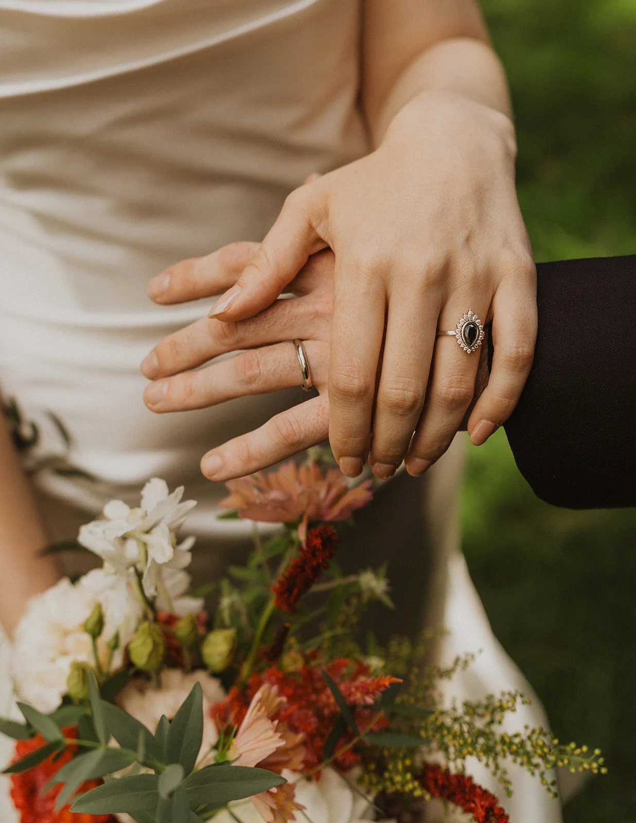 Both rings shown above a garden grown bouquet of dahlias and amaranth