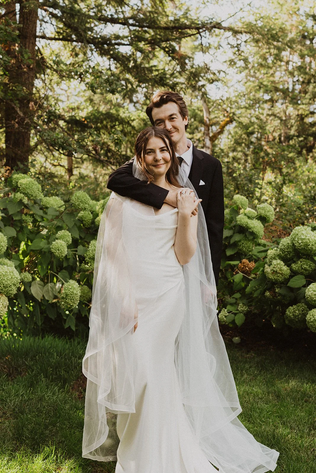 Couple portrait in front of the hydrangea border at Rocky Hill