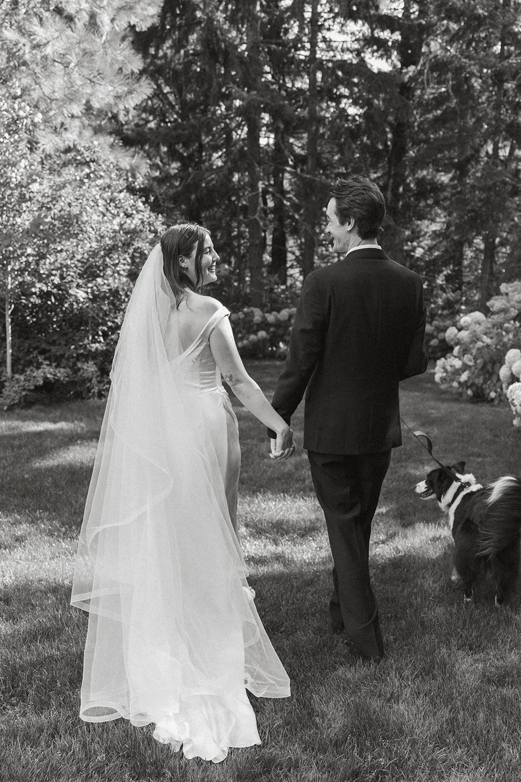 Hand in hand across the lawn with the dog alongside them
