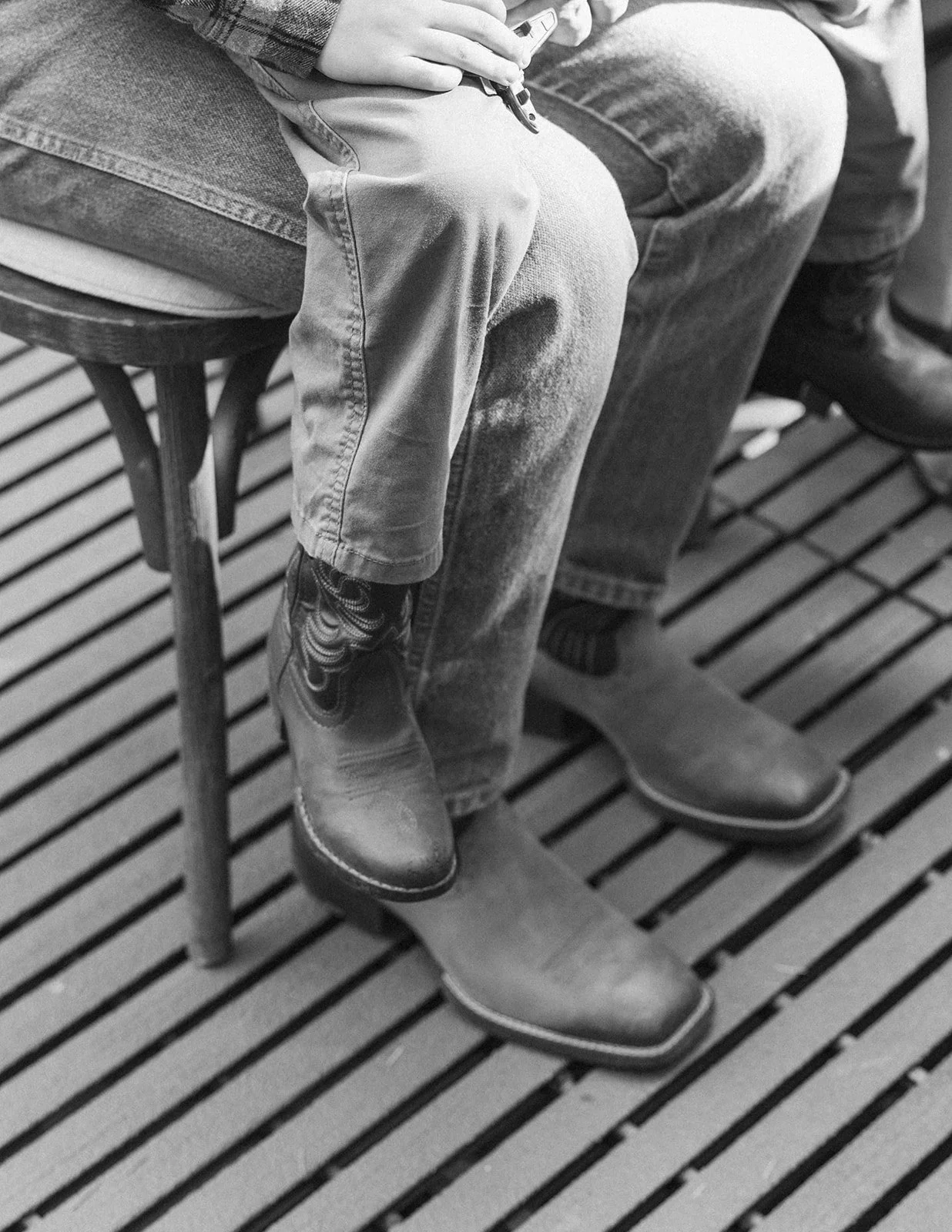 Guests in boots seated on the ceremony deck at a Rocky Hill wedding