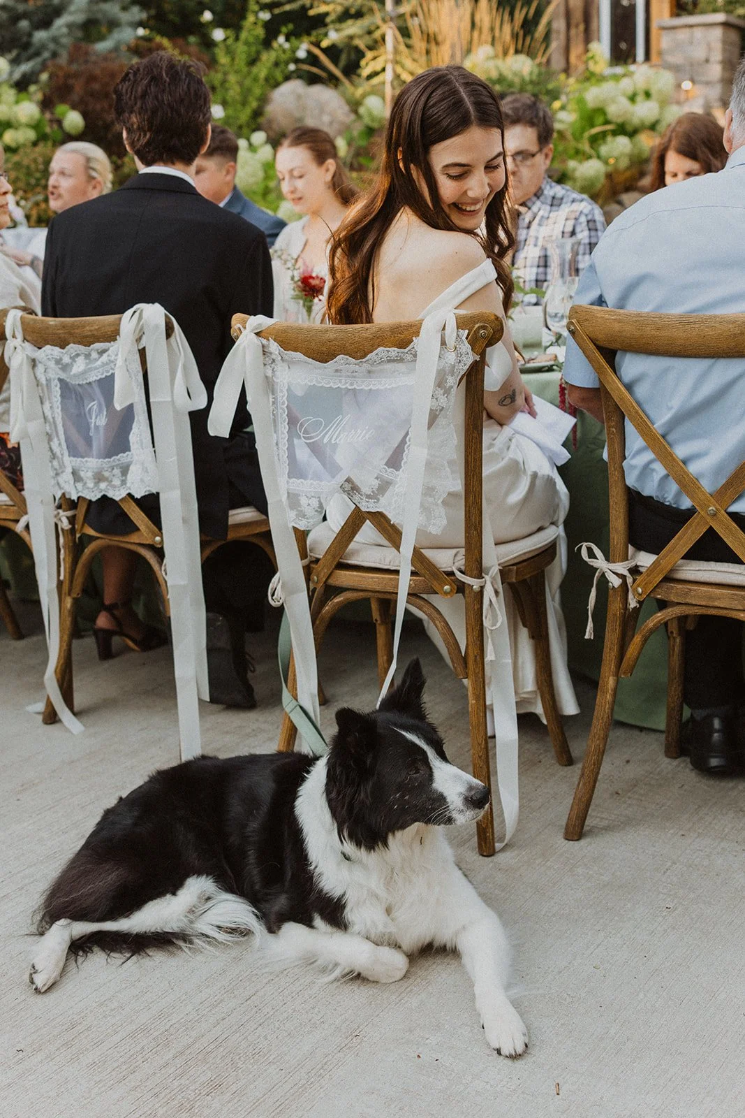 Looking down at the dog lying beside her chair through the long dinner