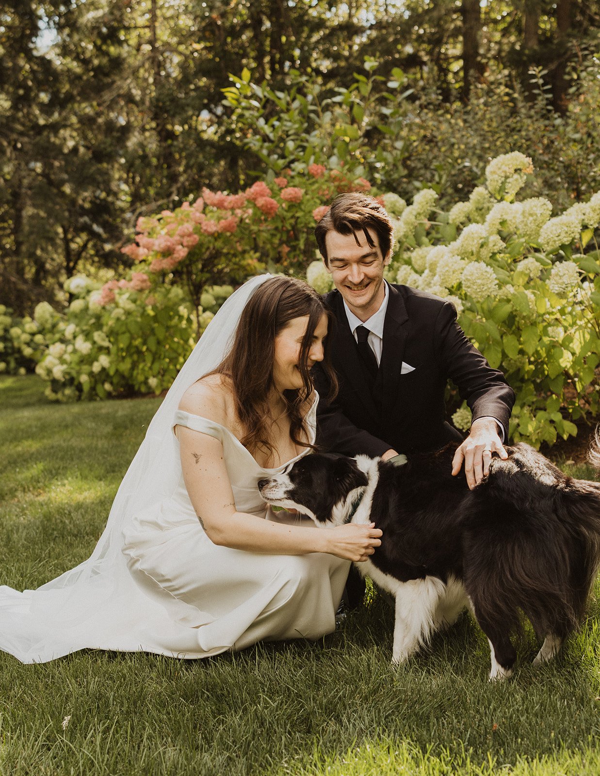 Kneeling in the grass with their rescue dog after a Rocky Hill wedding