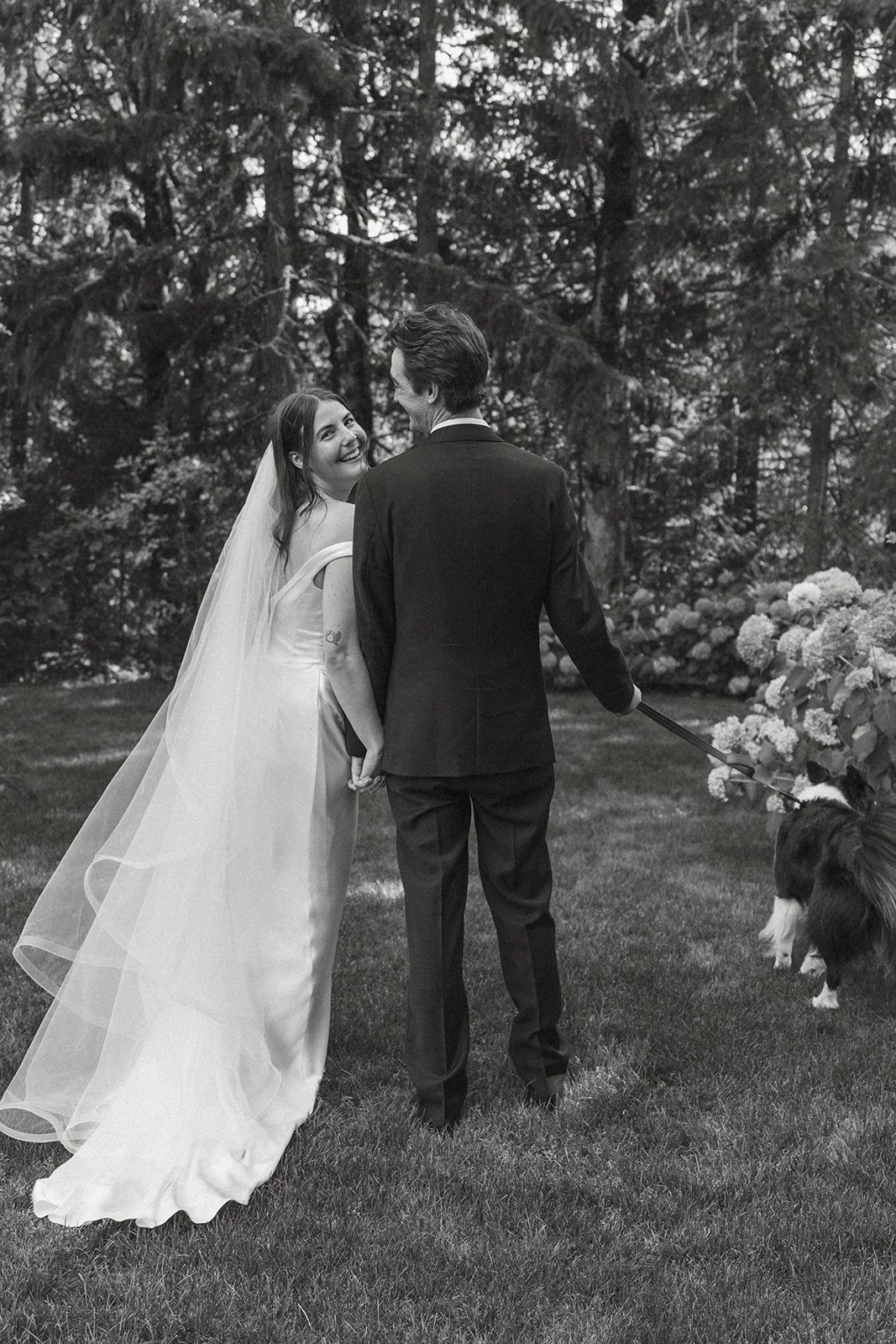 Glancing back over her shoulder while the dog leads the way