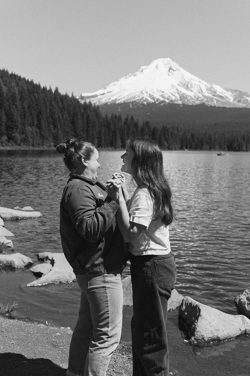 Black and white Trillium Lake portrait with hands clasped below the peak