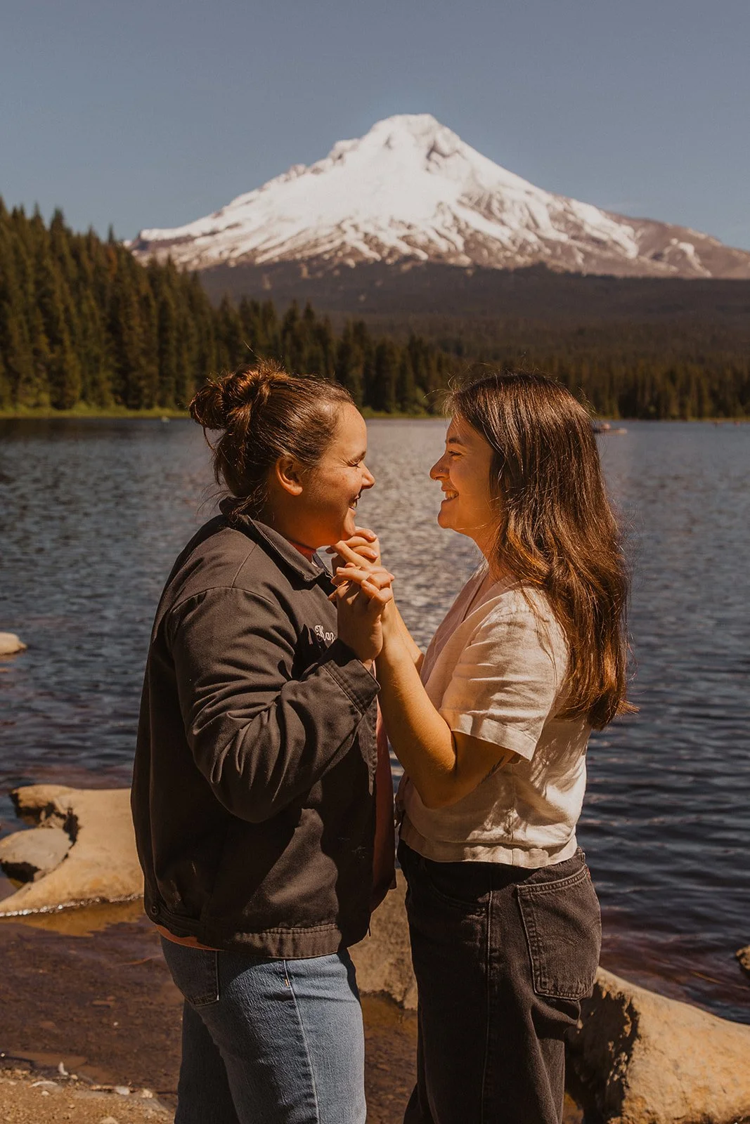 Facing each other with the peak centered behind them in engagement photos