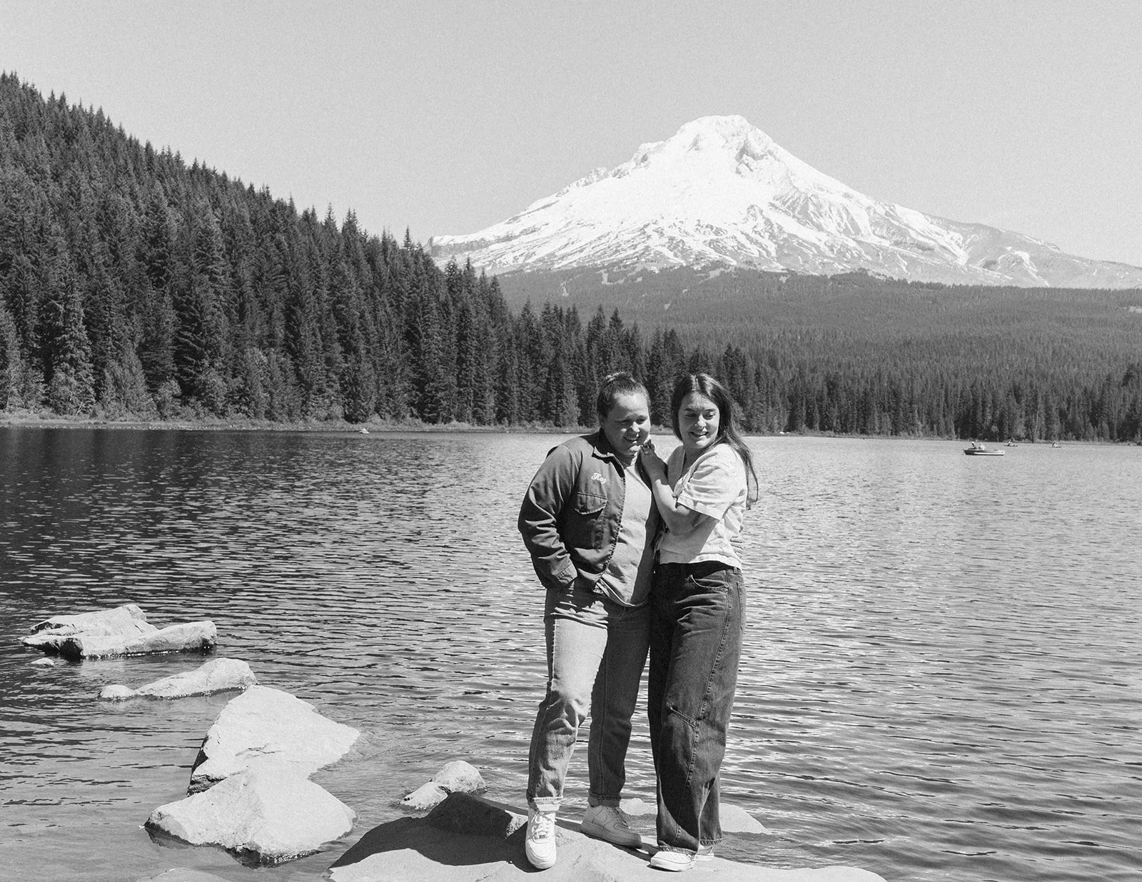 Black and white at Trillium Lake with fishing boats out behind them