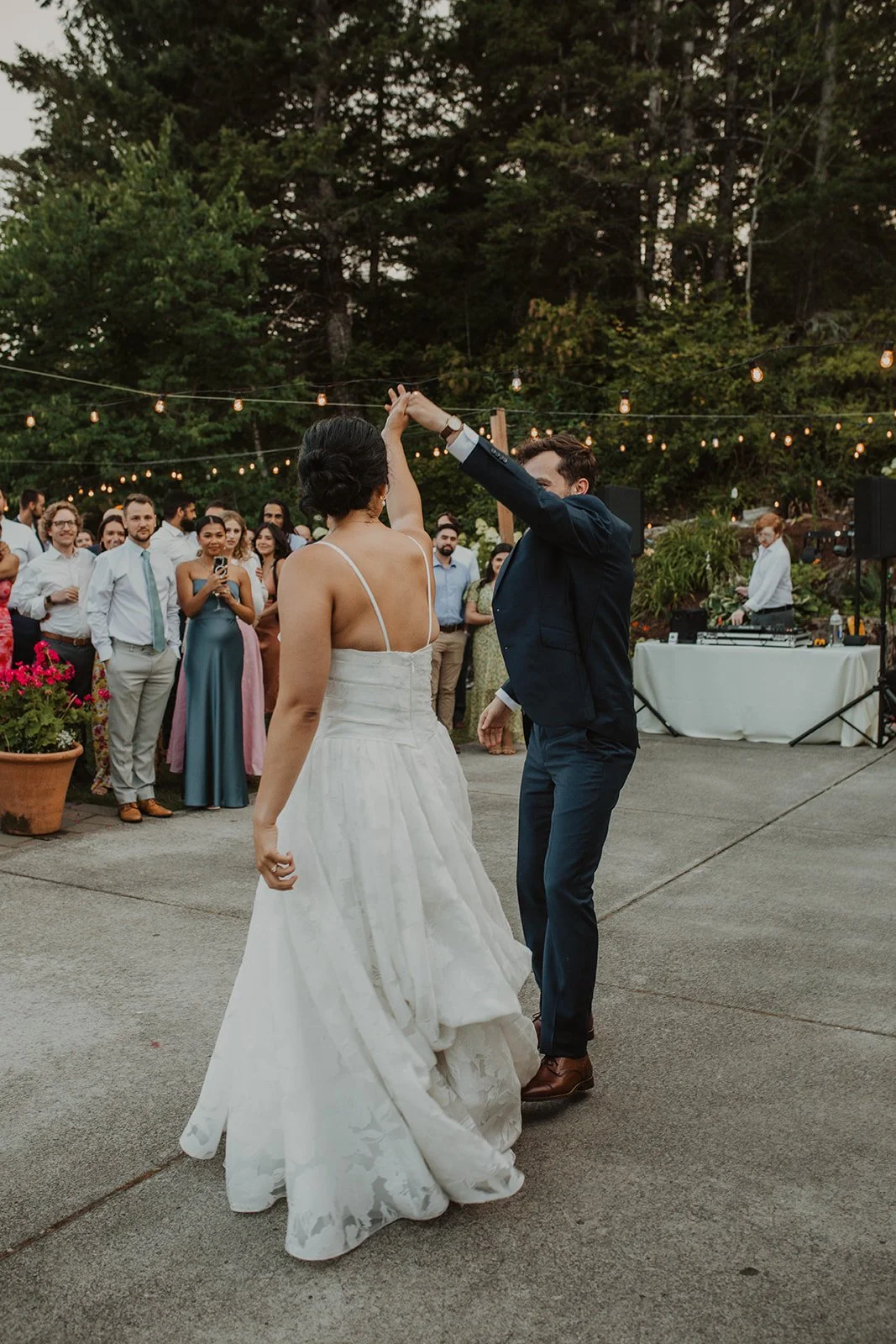 First dance on an outdoor floor with guests circled closely around