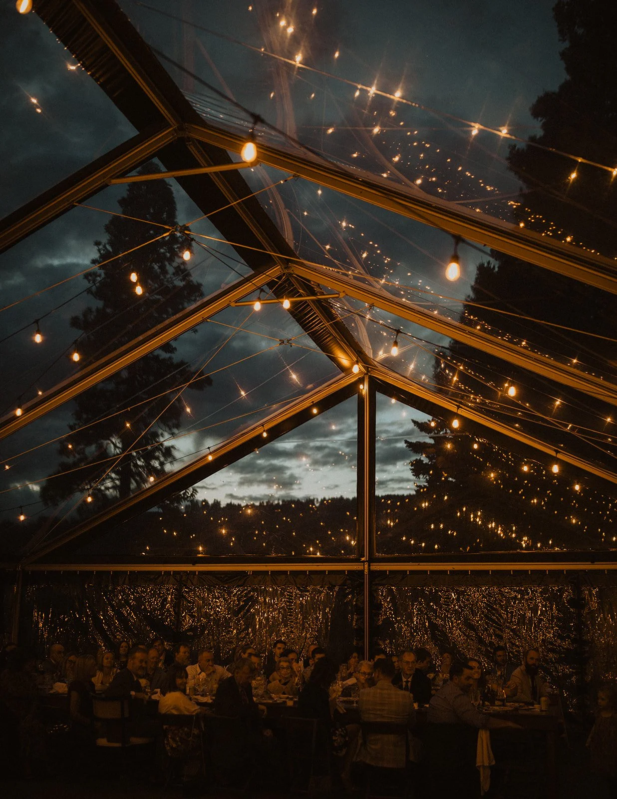 Dining under a clear roofed tent as heavy clouds gather above