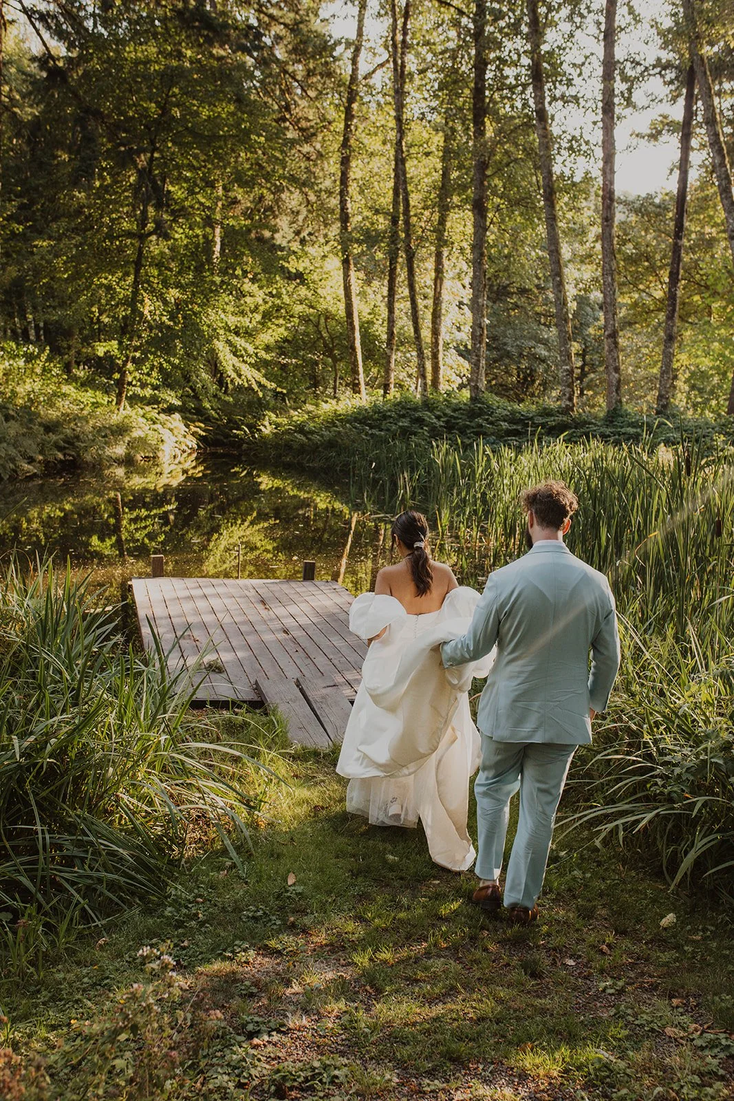 Heading toward a wooden dock through cattails and tall summer grass