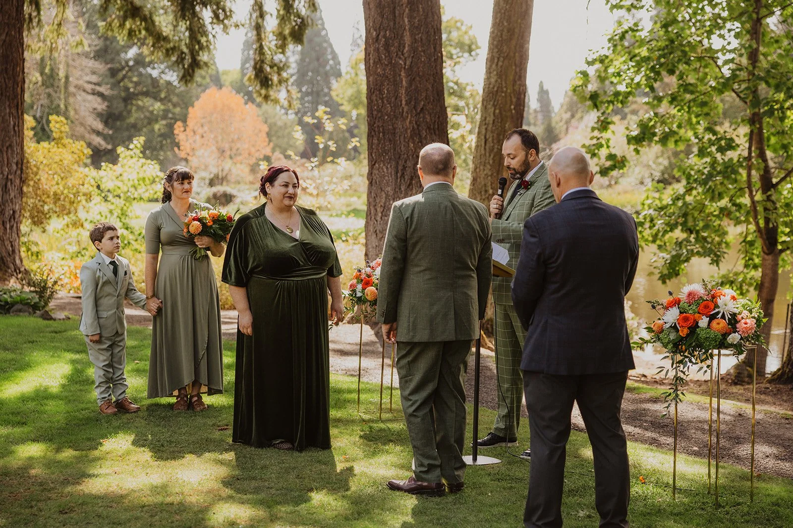 Officiant speaks into a microphone at a Crystal Springs Rhododendron Garden wedding