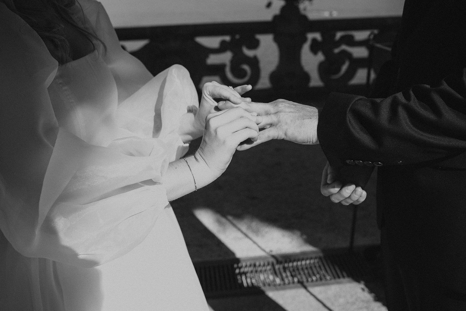 Bride placing a wedding ring on the groom's finger during their intimate Lake Como elopement ceremony.