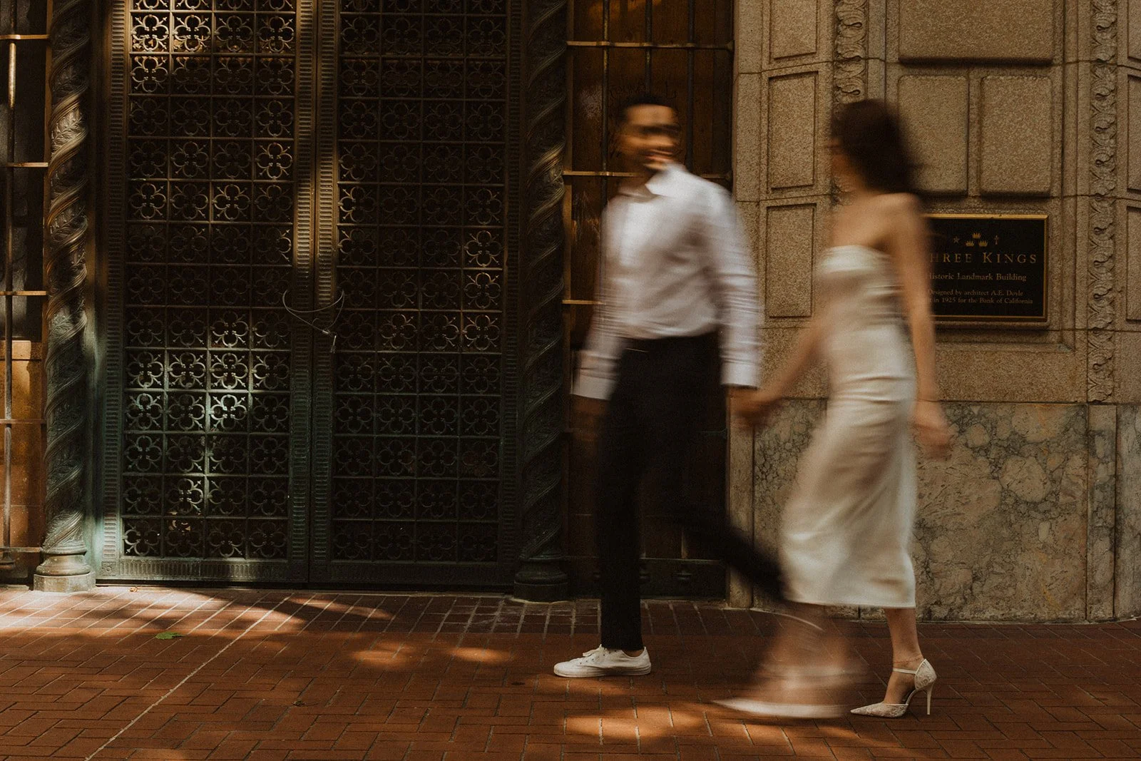 Charlotte and Lucas walking together during their downtown Portland engagement photos