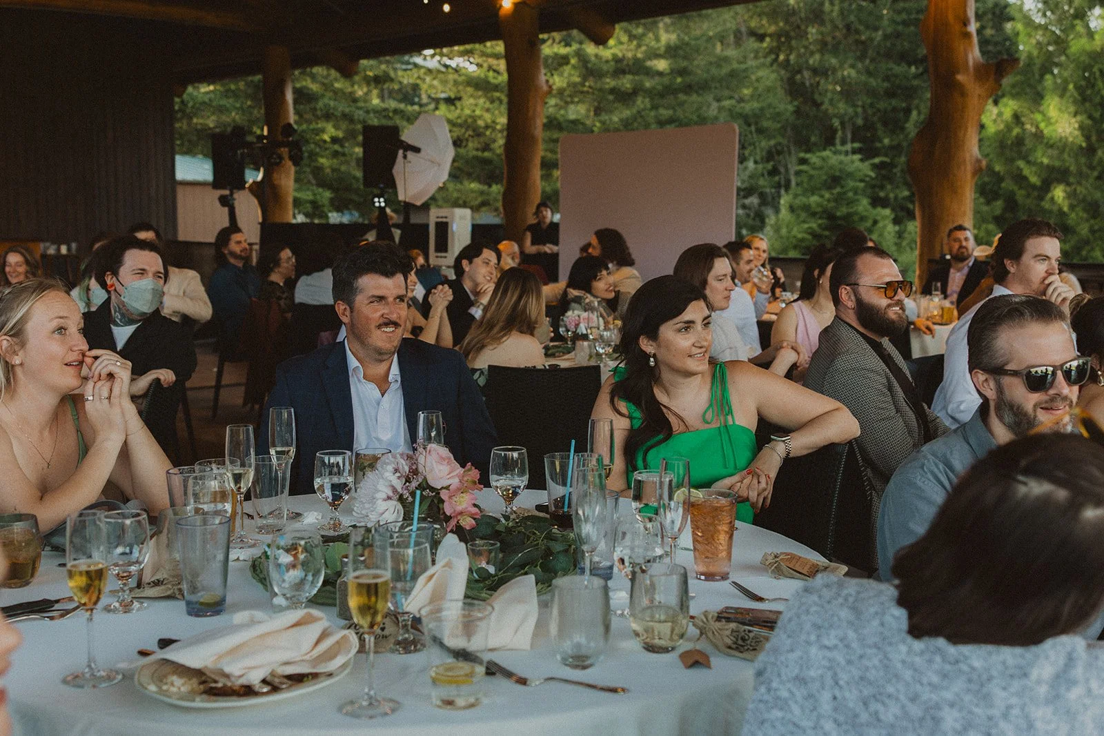 Guests gathered around reception tables during dinner and speeches at a Skamania Lodge wedding.
