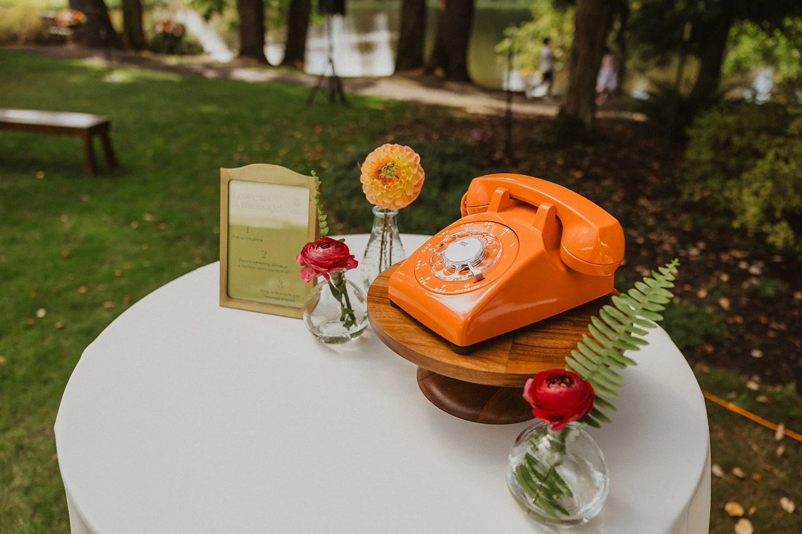 Vintage orange rotary phone set up as an audio guest book at Crystal Springs