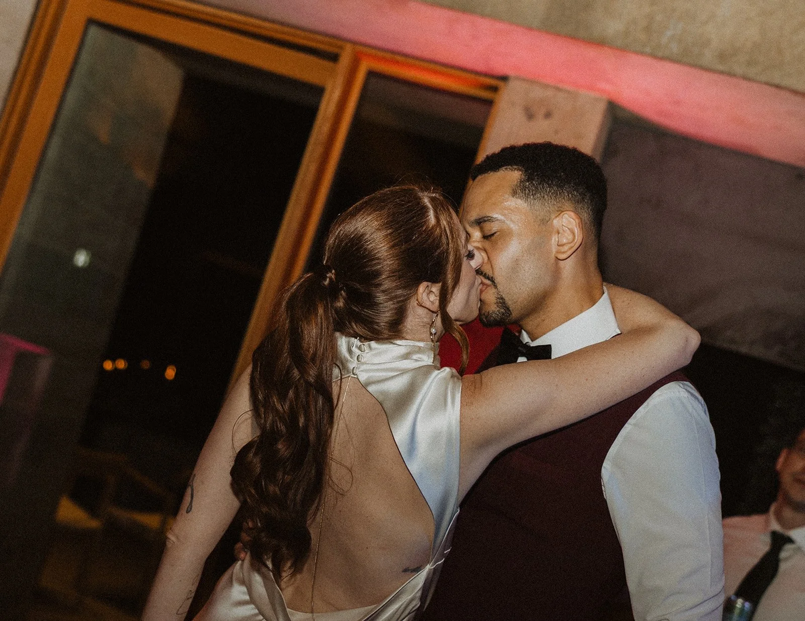 Couple kissing at the end of their winery reception