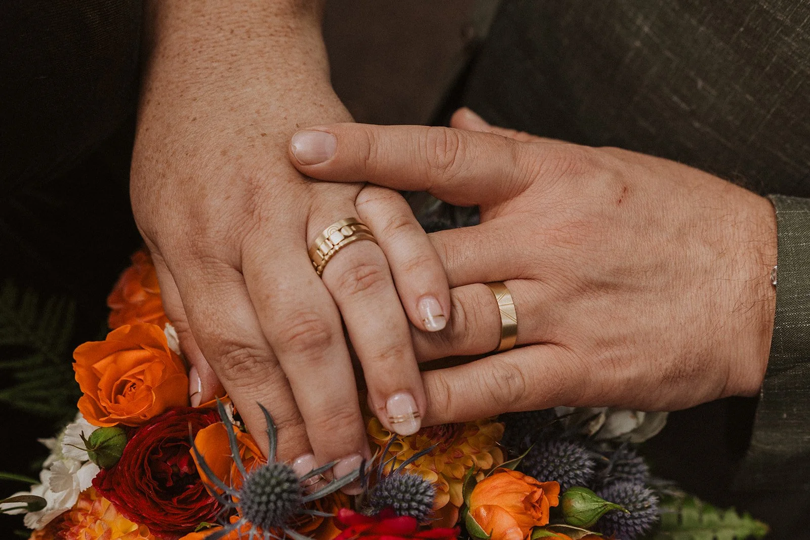 Walking away hand in hand under the rhododendrons at an Oregon garden wedding