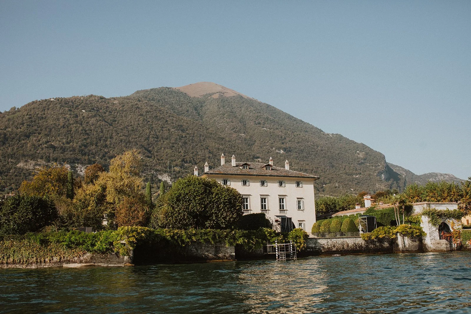 Historic villa overlooking Lake Como with mountain views, waterfront gardens, and classic Italian architecture.
