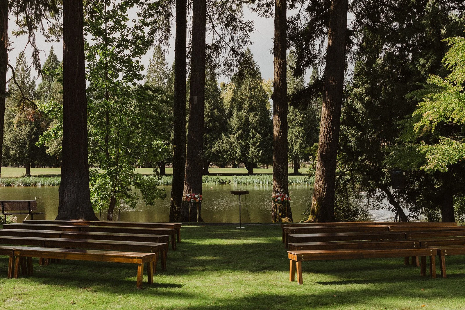 Wooden benches set out on the Meadow lawn at Crystal Springs before guests arrive