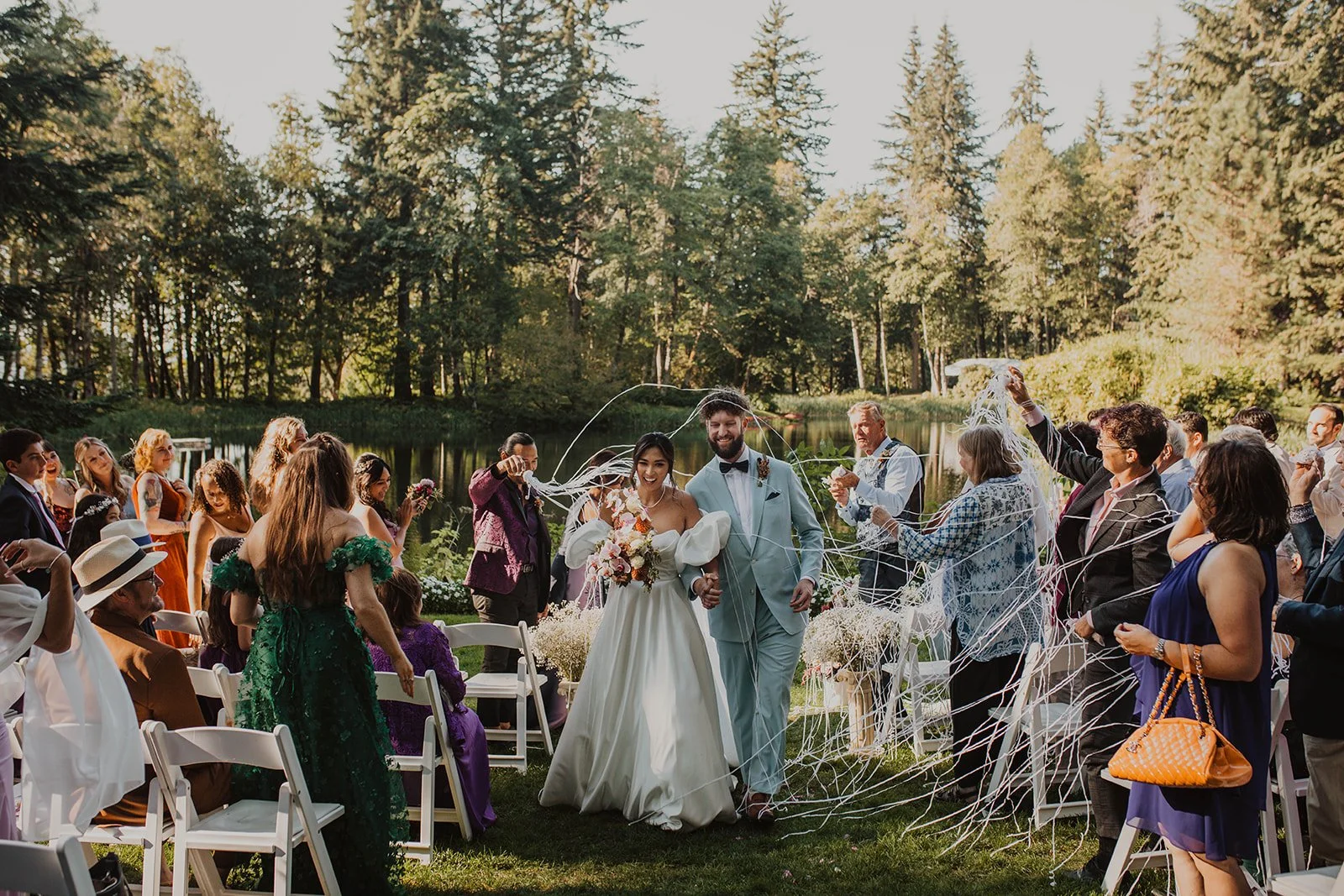 Streamers flying overhead as the newlyweds walk back up the aisle