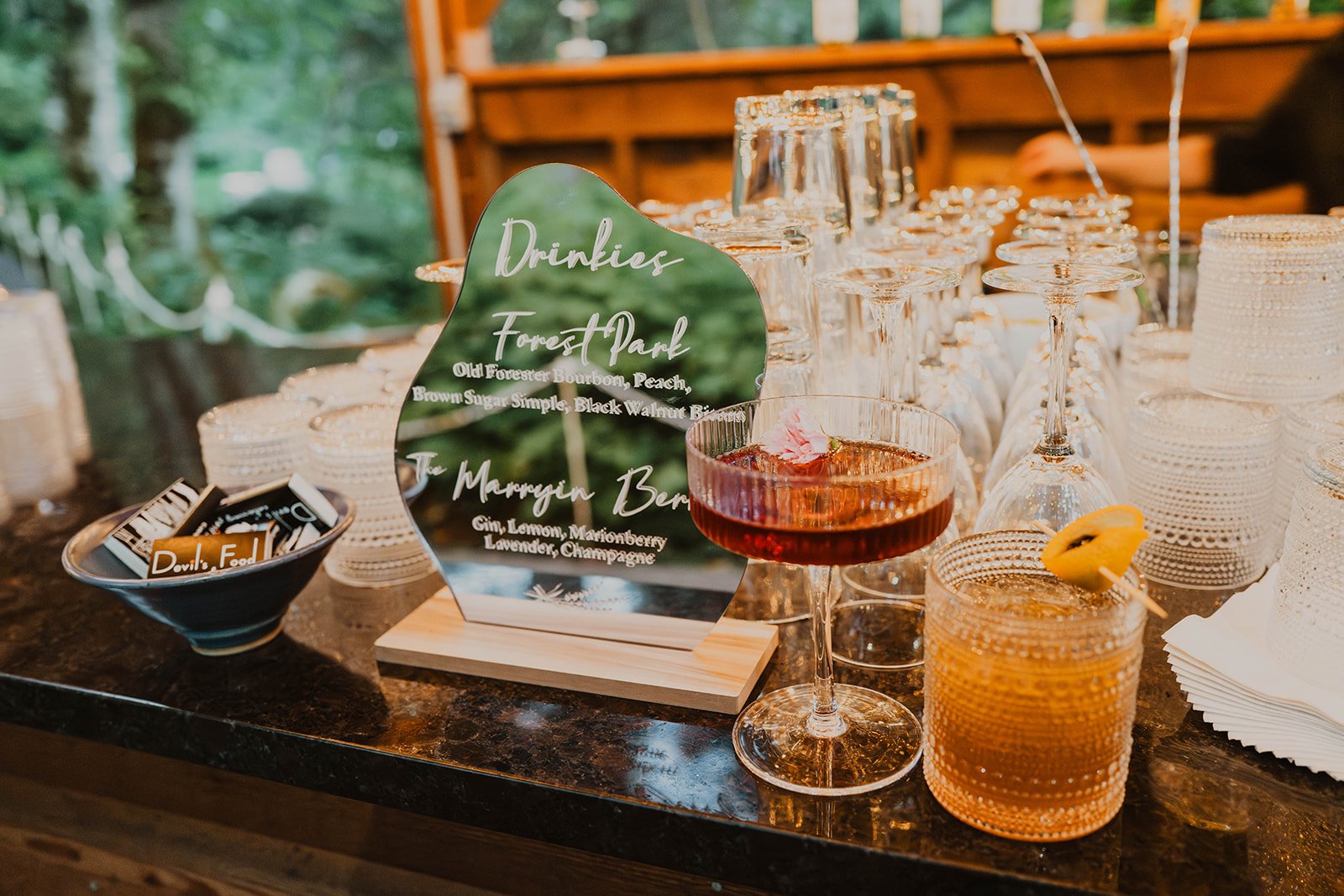 Signature cocktail menu with custom wedding drinks displayed at the reception bar during a Bridal Veil Lakes wedding in Oregon.