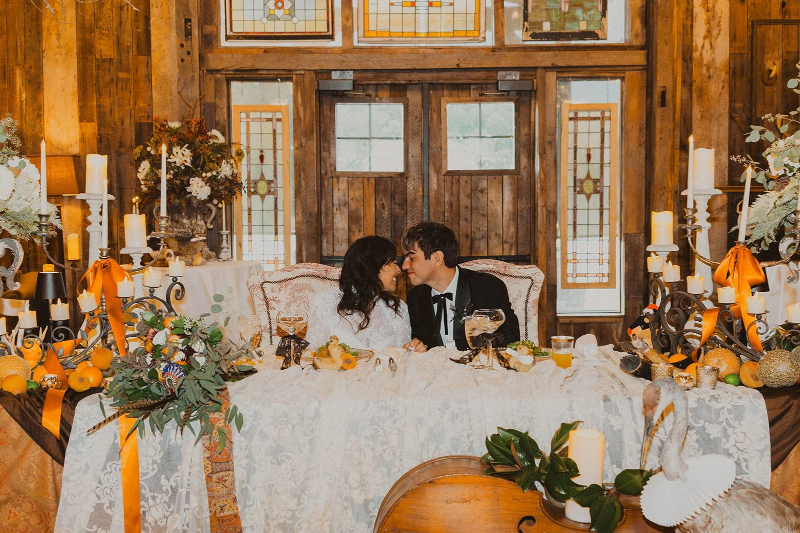 Bride and groom seated at their decorated sweetheart table during the reception at Bright Morning Farm.