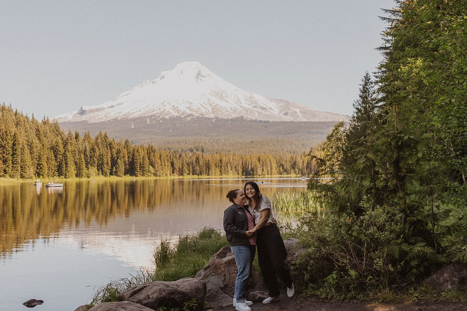 Smiling at the camera with Mount Hood behind them in golden light