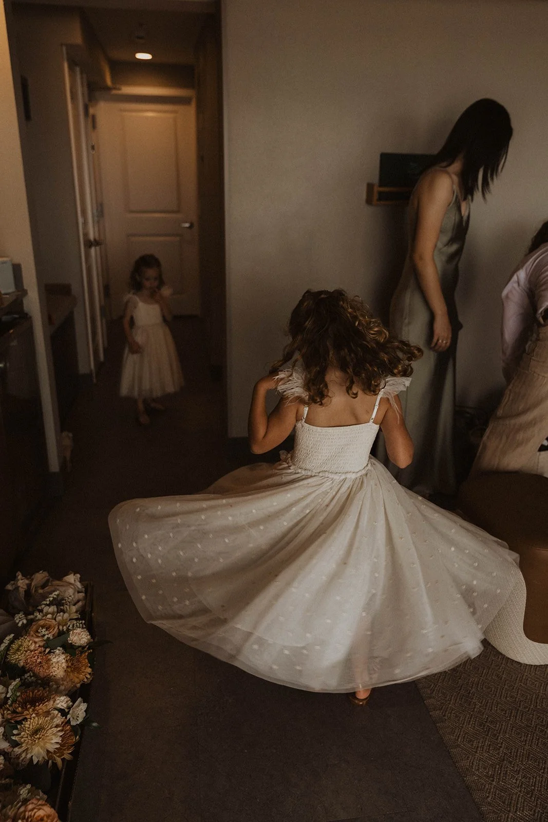Emotional candid moment between a bridesmaid and flower girl during wedding preparations at Cannon Beach