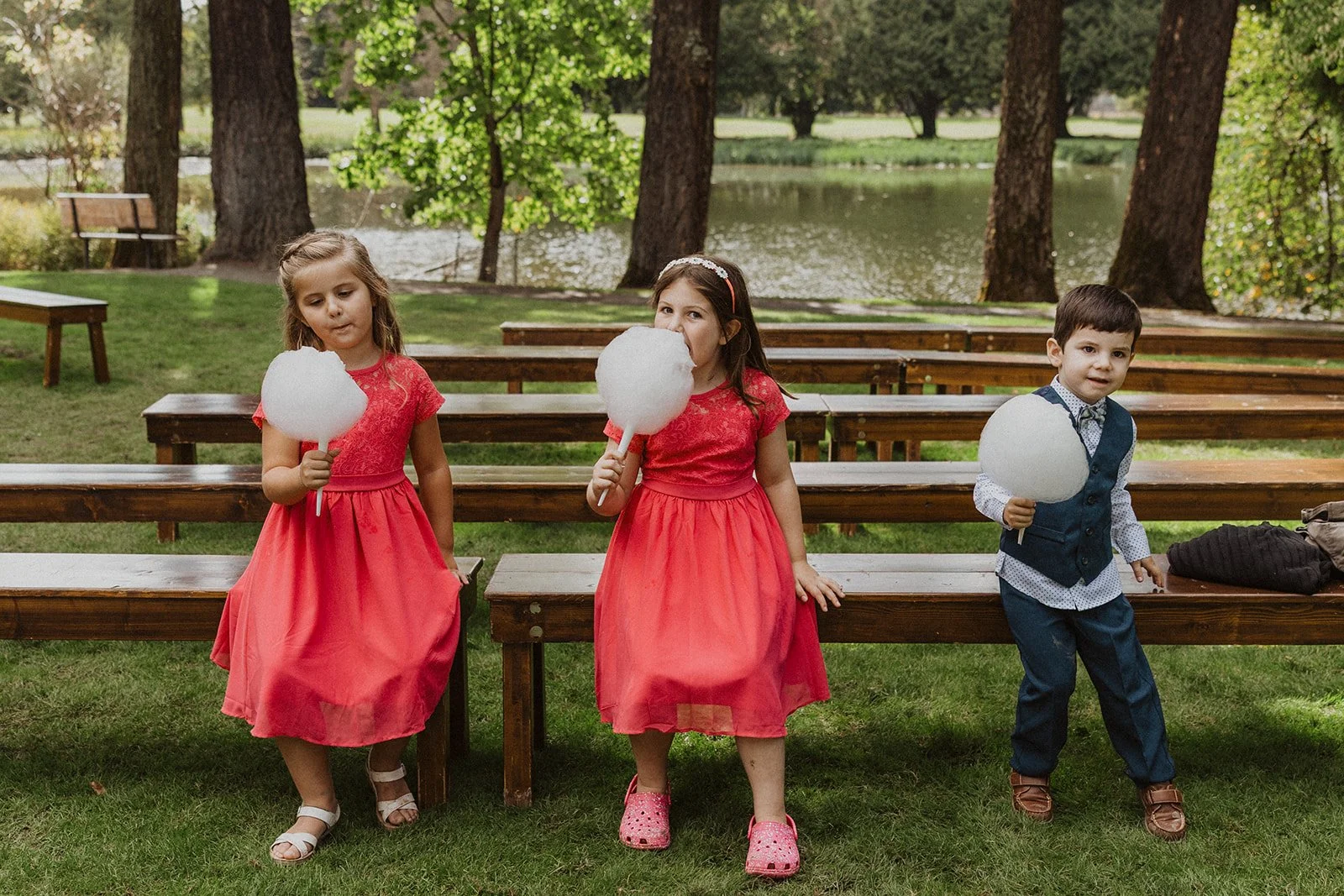Kids compare cotton candy cones under fir trees at Oregon garden weddings