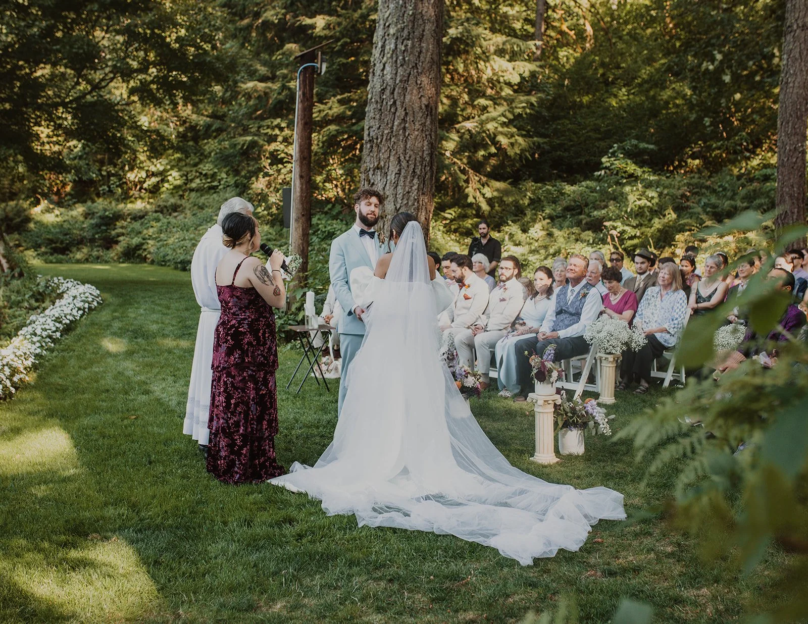 Outdoor forest ceremony at Bridal Veil Lakes with the couple exchanging vows surrounded by family and friends.