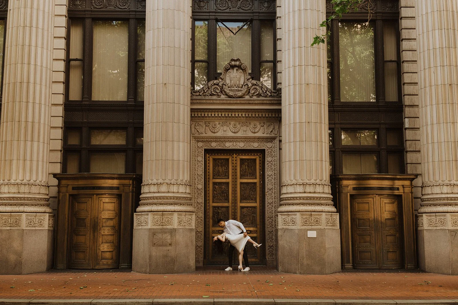 Documentary-style engagement photo of Charlotte and Lucas in downtown Portland