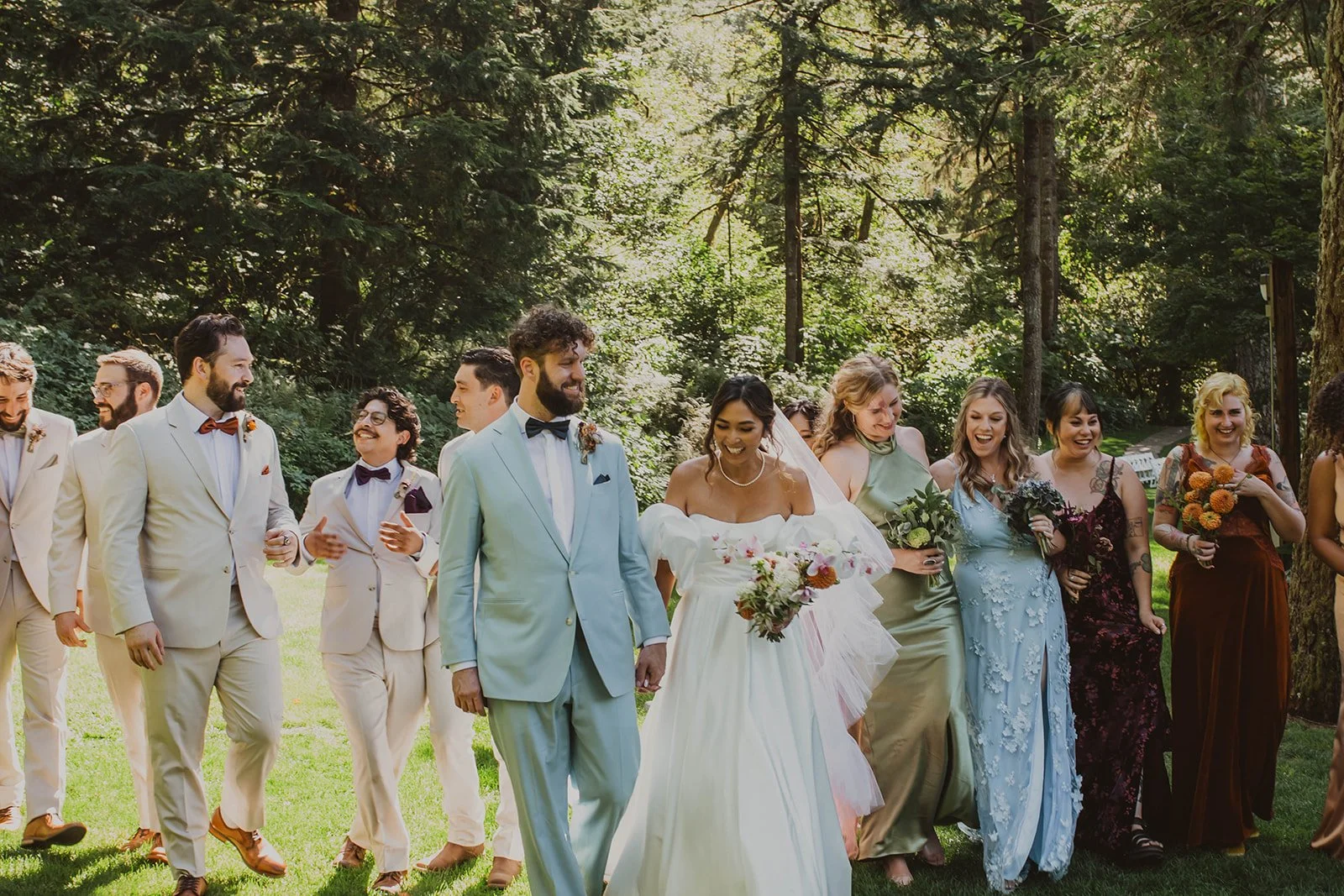 Bride and groom walking with their wedding party through the lawn at Bridal Veil Lakes during an outdoor Oregon wedding.
