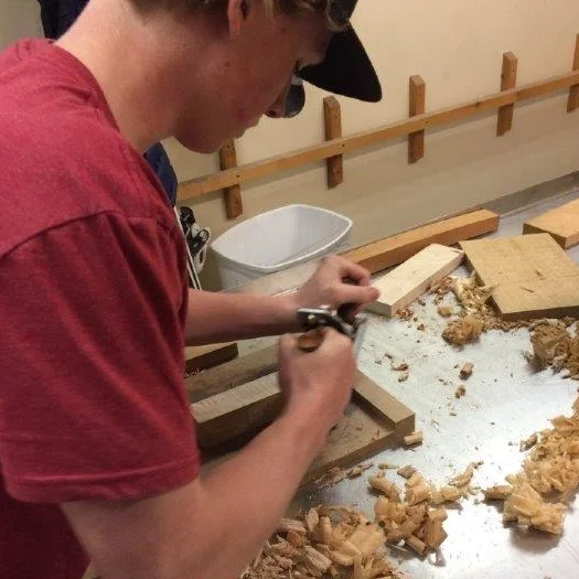 A Northwood student works the hand planer during the spring `18 LEAP woodworking course.