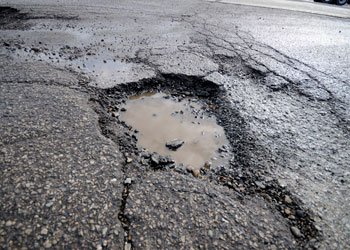 why-asphalt-driveways-pothole-in-the-winter-grand-rapids-asphalt-paving.jpg