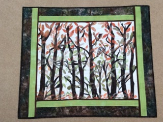 Season's Change 28” X 33” $300 Materials: Commercial fabric. Applique, painted fusible webbing. Technique: Designed, pieced, and quilted by artist.