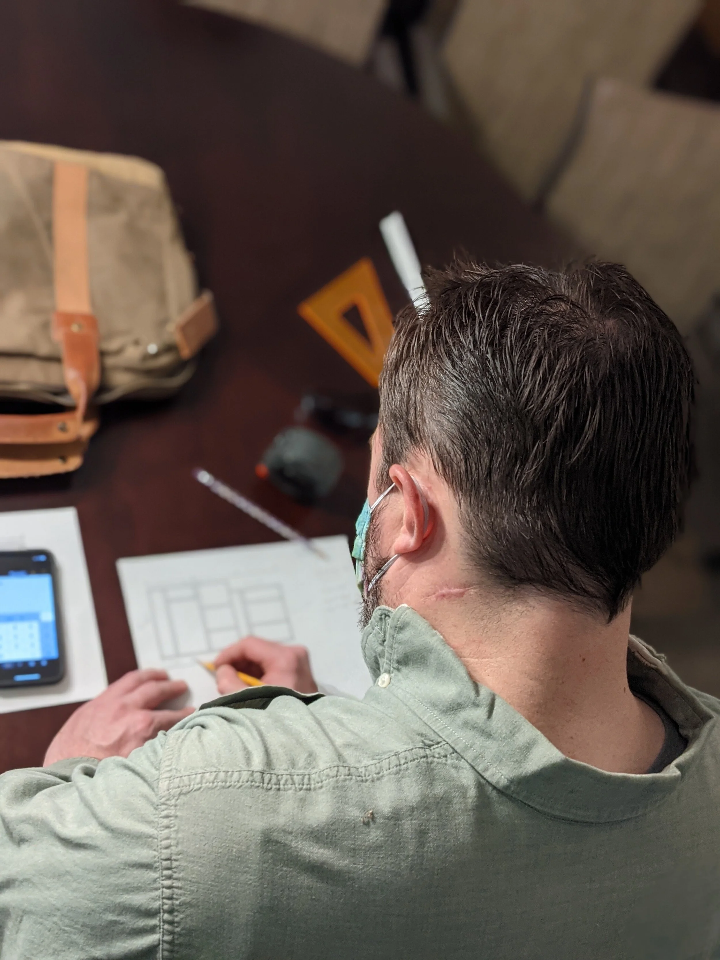  Mark double checking his math on the blueprint 