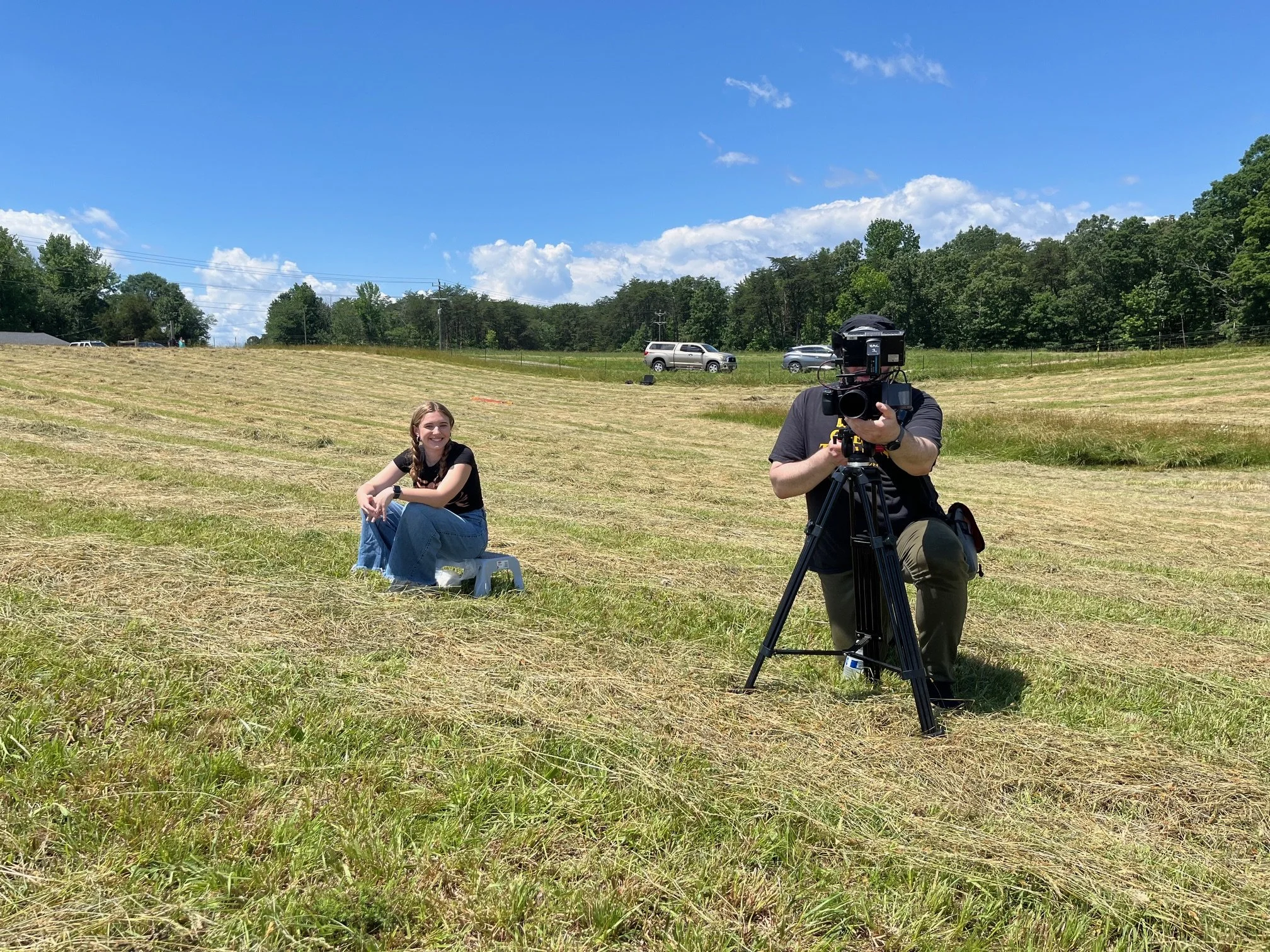  Hunter and Lauren opposite a couch in a field 