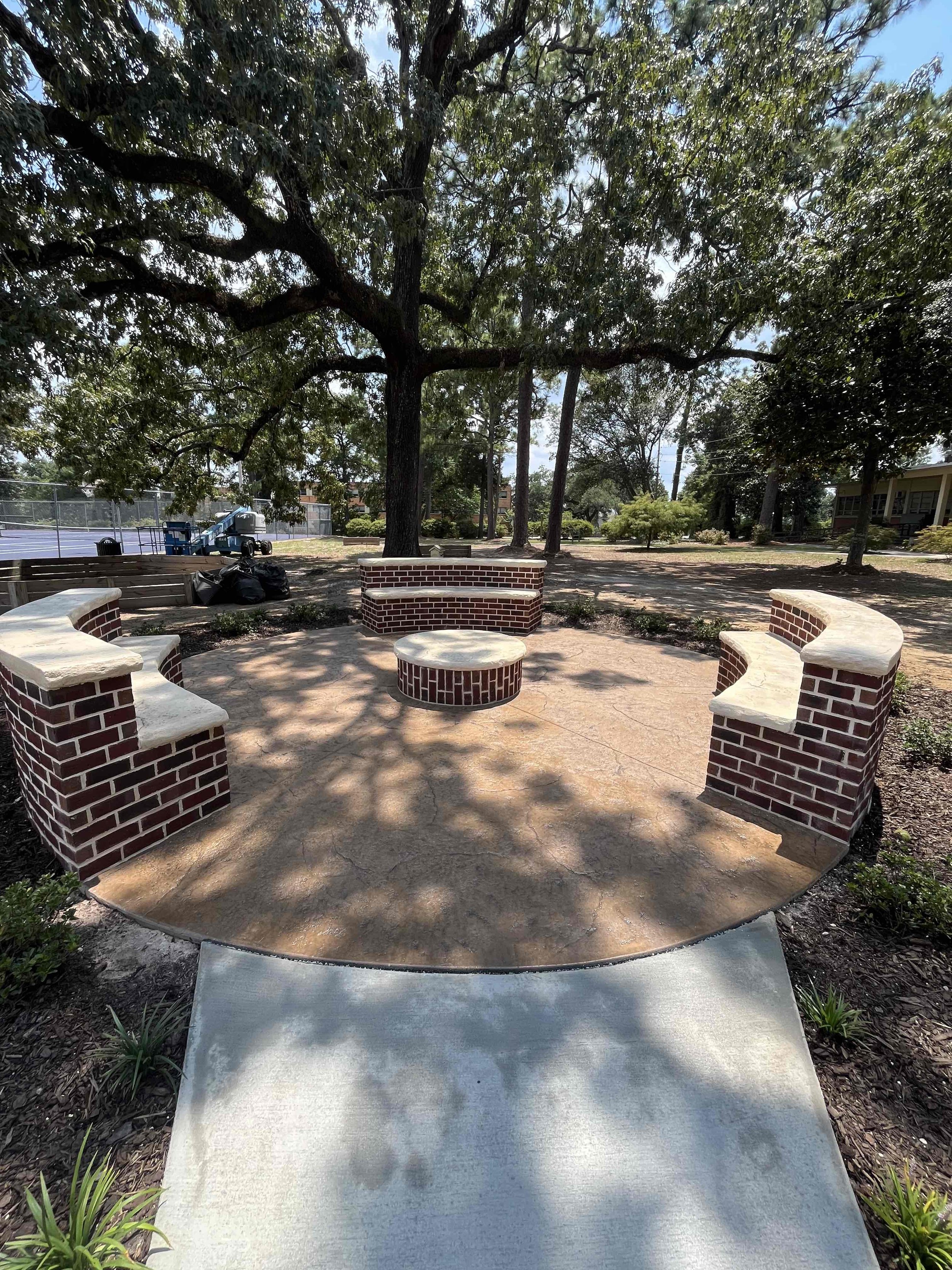 Outdoor space at Springhill College with Stamped Concrete and Brick Seating Walls