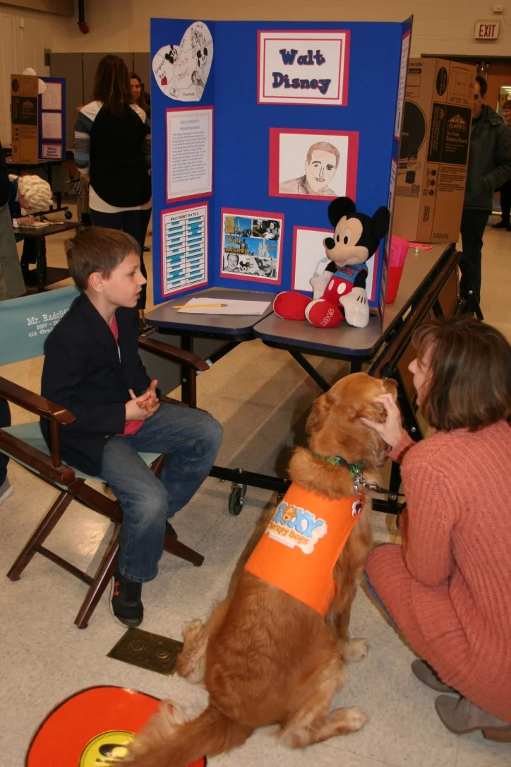 Scarlett listening to Elliot as Walt Disney at the Wax Museum
