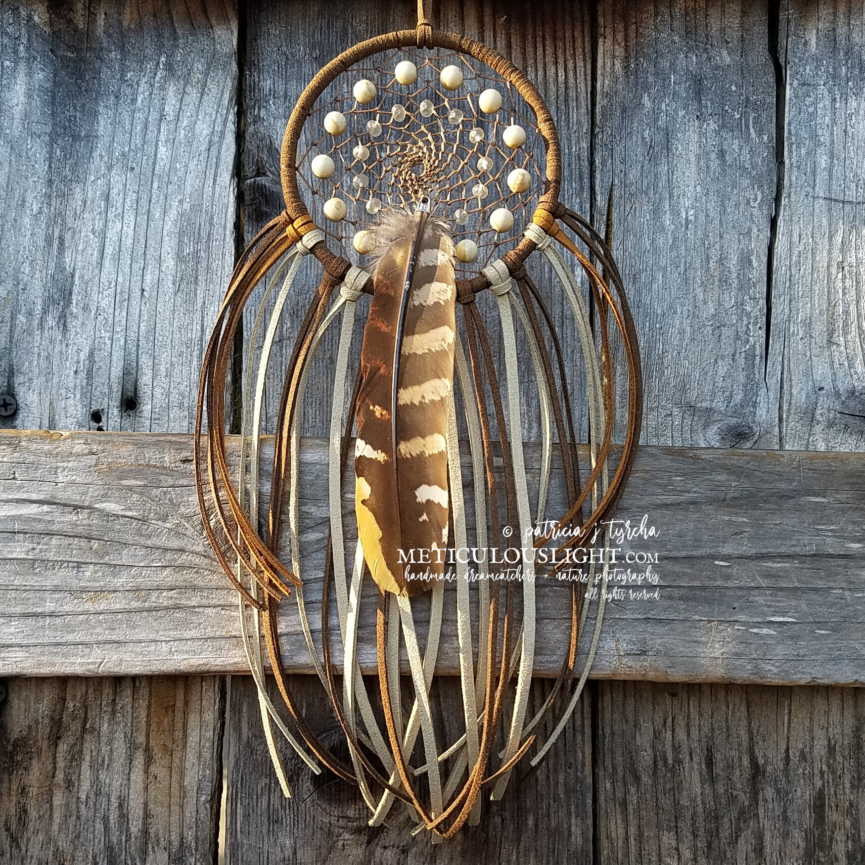 brown dream catcher with feather.jpg