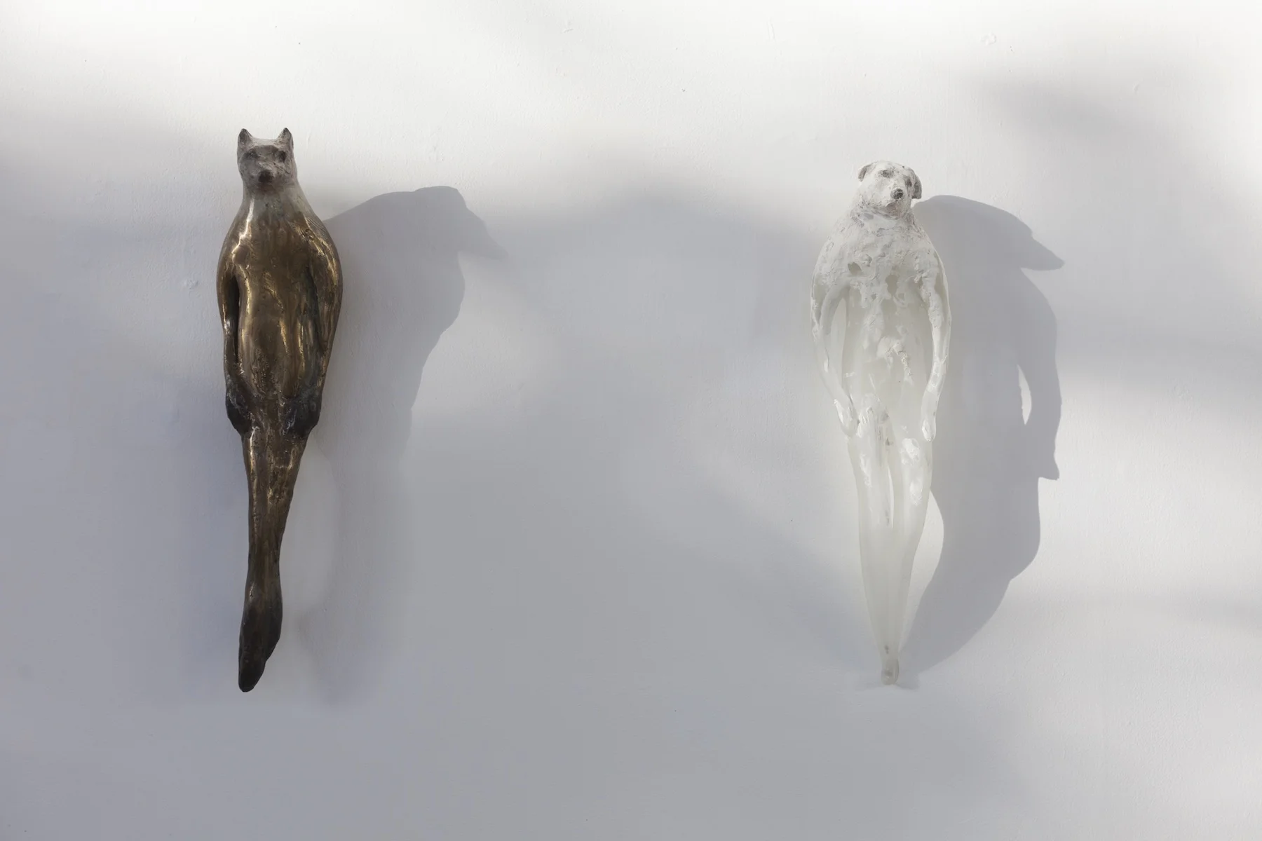  “Bronze Buddhi II,” (left) 2016 (edition of 6) Cast bronze with unique patina, 18 x 5 x 4 inches  “Rook Boy,” (right) 2013 Hand blown pigmented glass and marble mix, 19 x 5 x 4 inches 
