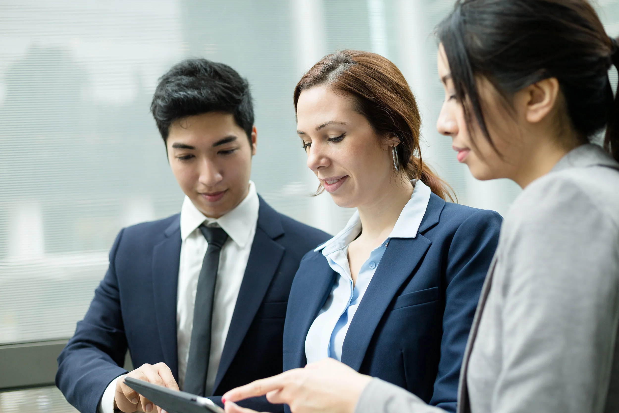 Business people discuss on tablet computer