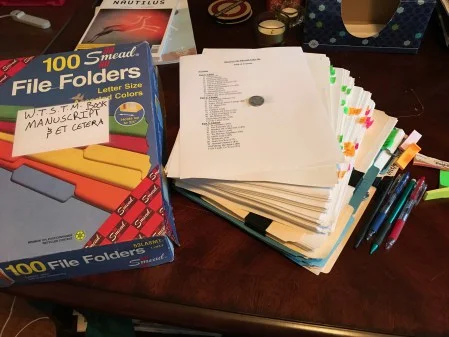 The many versions of my high school novel, "Wherever the Sidewalk Takes Me," which I obsessively edited, combed through, and kept in this box. And yes, that is a Michigan state quarter taped to the table contents—and yes, a Michigan state quarter has to do with the plot.