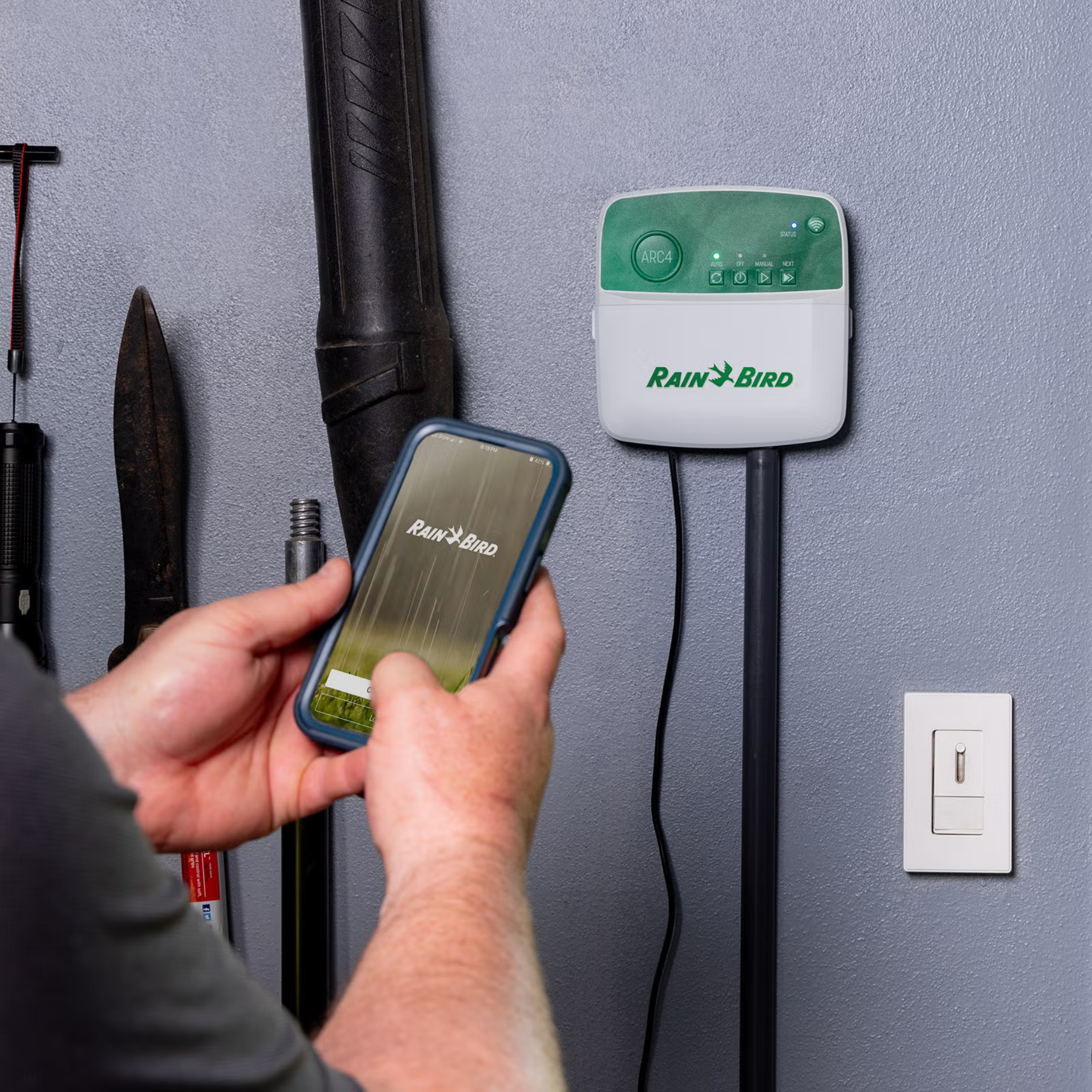 Homeowner using Rain Bird smart irrigation controller app to improve water conservation and reduce outdoor water waste