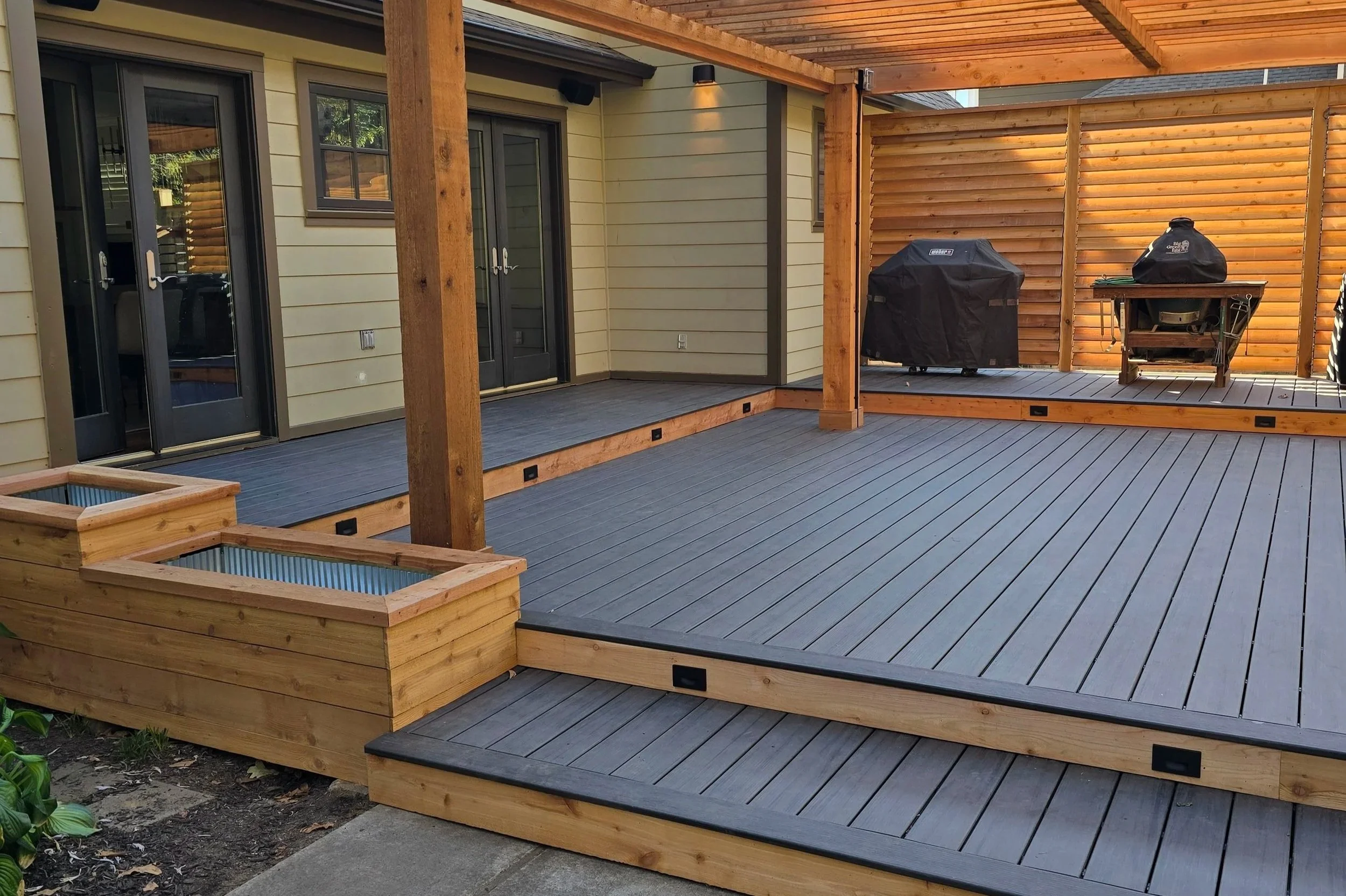 Custom composite deck with covered pergola and privacy wall at a residential home in Northwest Arkansas, installed by ABI Systems