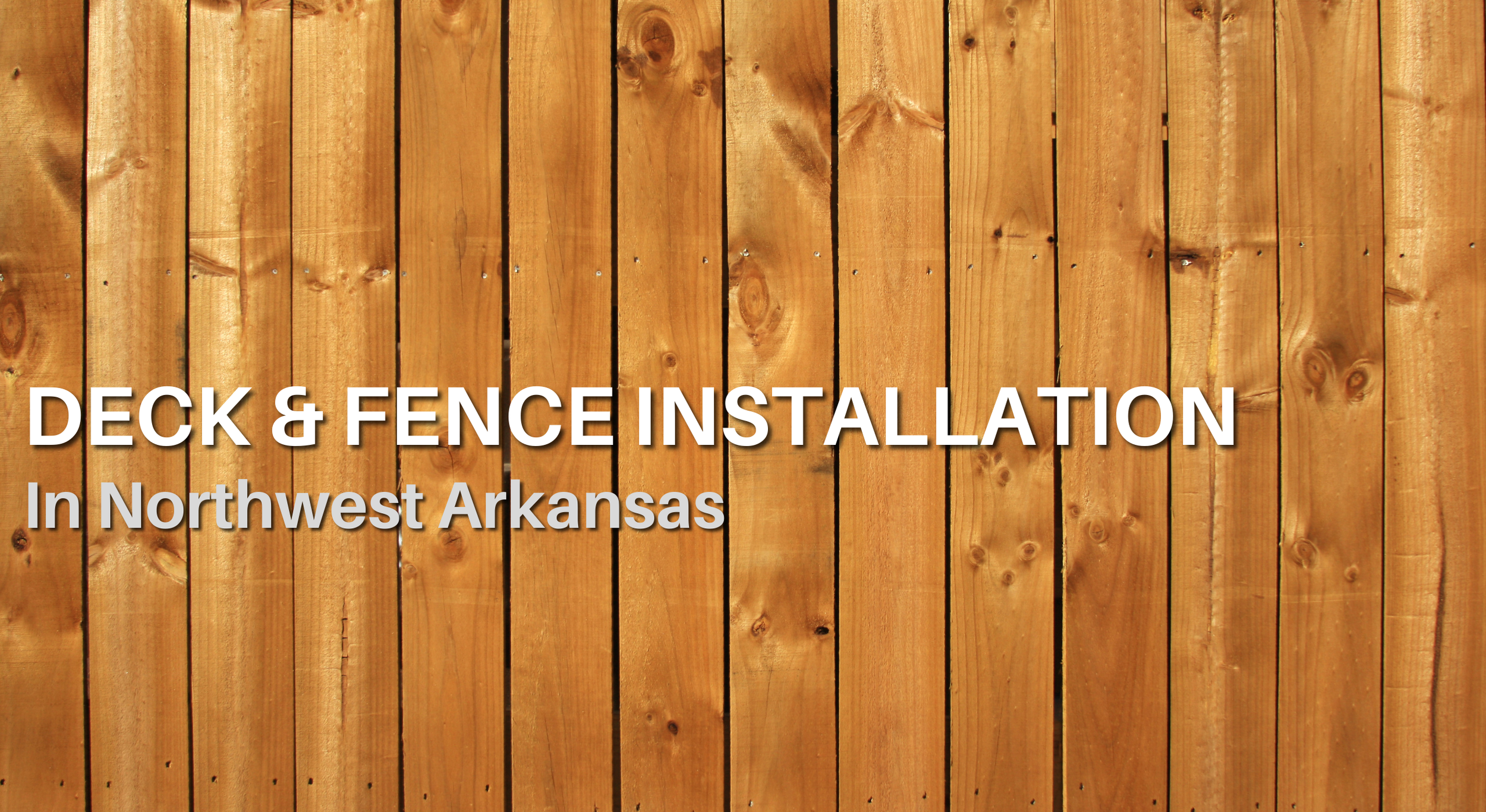 Wood privacy fence panels forming a clean, natural backdrop for residential deck and fence installations in Northwest Arkansas