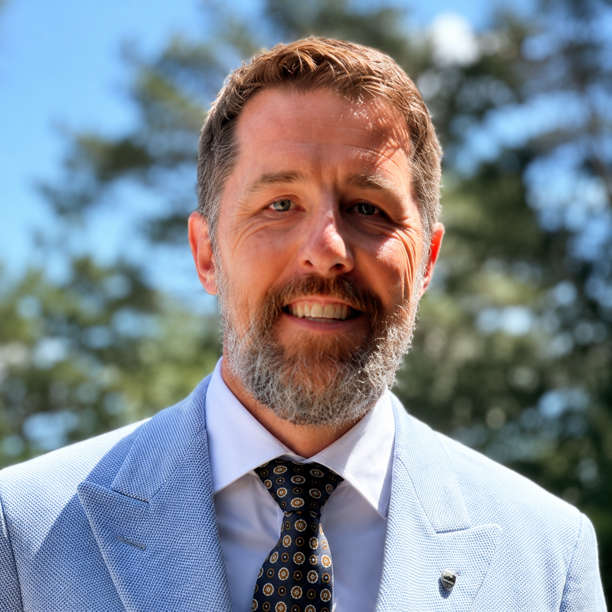 Nick Khilling, owner of ABI Systems, pictured outdoors in professional business attire in Northwest Arkansas