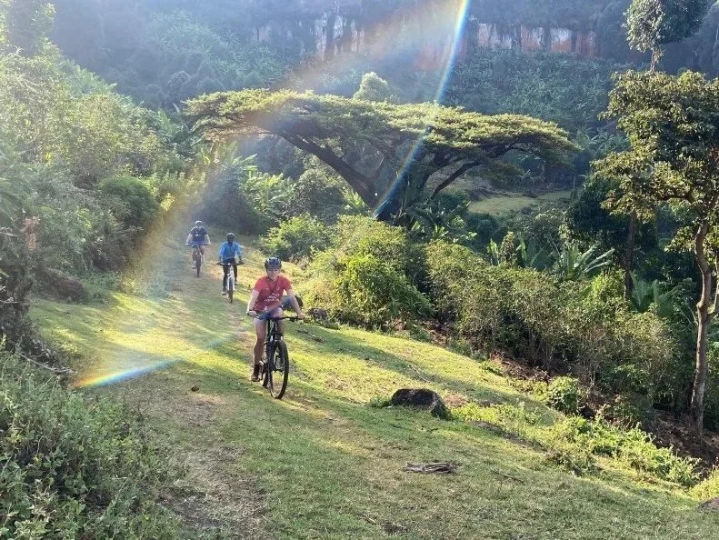 Romy mountain biking on the beautifully green trails near Kapchorwa Town