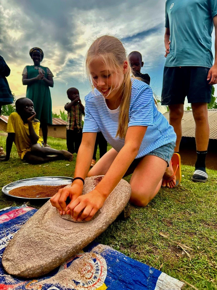 Child grinding millet