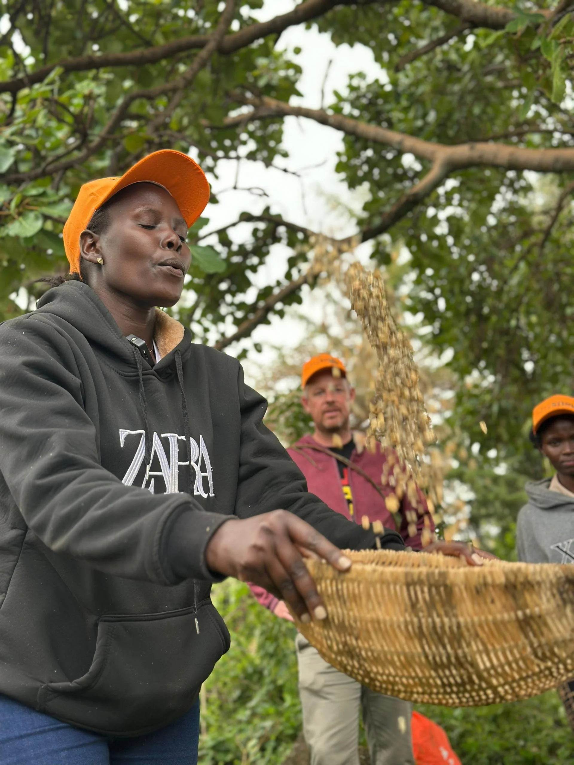 Becky winnowing coffee during a Community experience at Masha Coffee