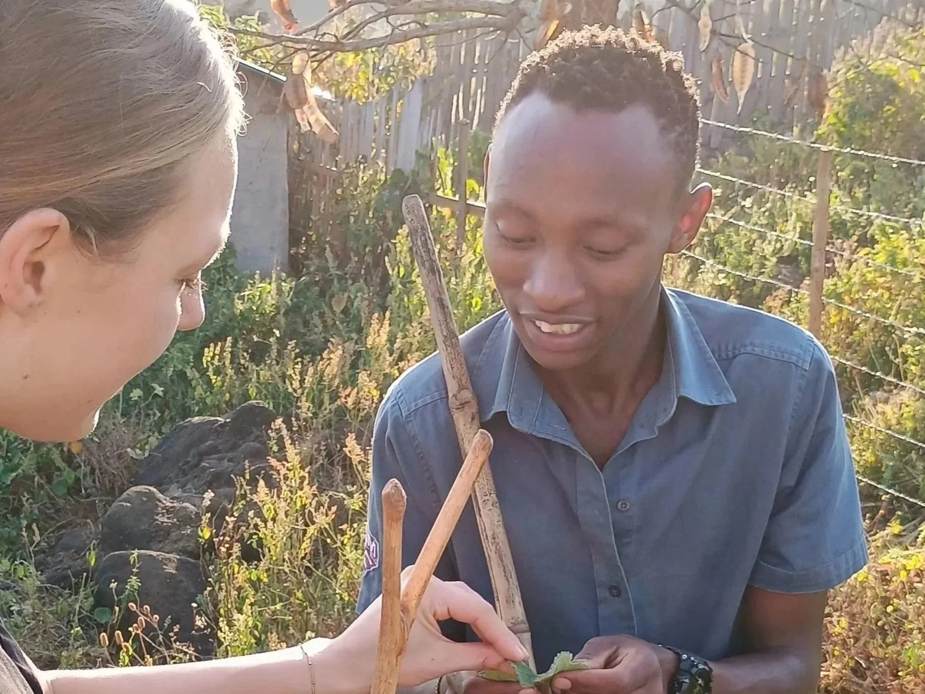 Kapchorwa Nature Walk guide Rommy with Dutch adventure traveler Romy showcasing a local plant